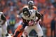 DENVER, CO - OCTOBER 13: Wide receiver Justin Blackmon #14 of the Jacksonville Jaguars makes a pass reception and cornerback Champ Bailey #24 of the Denver Broncos makes the tackle at Sports Authority Field at Mile High on October 13, 2013 in Denver, Col