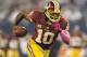 ARLINGTON, TX - OCTOBER 13: Robert Griffin III #10 of the Washington Redskins runs the ball against the Dallas Cowboys at AT&T Stadium on October 13, 2013 in Arlington, Texas. The Cowboys defeated the Redskins 31-16. (Photo by Wesley Hitt/Getty Images)