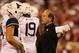 Sep 7, 2013; Norman, OK, USA; West Virginia Mountaineers head coach Dana Holgorsen talks with quarterback Paul Millard (14) during a timeout in the third quarter against the Oklahoma Sooners at Gaylord Family - Oklahoma Memorial Stadium. The Oklahoma Soon