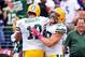 Oct 13, 2013; Baltimore, MD, USA; Green Bay Packers quarterback Aaron Rodgers (12) is congratulated by fullback John Kuhn (30) after throwing a 64 yard touchdown pass to wide receiver Jordy Nelson (not pictured) in the third quarter against the Baltimore