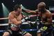 LAS VEGAS, NV - OCTOBER 12: WBO welterweight champion Timothy Bradley Jr. (R) lands a punch to the head of Juan Manuel Marquez during their bout at the Thomas & Mack Center on October 12, 2013 in Las Vegas, Nevada. Bradley won in a split-decision. (Phot