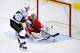 RALEIGH, NC - OCTOBER 11: Dwight King #74 of the Los Angeles Kings beats Cam Ward #30 of the Carolina Hurricanes for a goal during the third period at PNC Arena on October 11, 2013 in Raleigh, North Carolina. The Kings won 2-1 in a shootout. (Photo by Gr