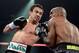 LAS VEGAS, NV - OCTOBER 12: Juan Manuel Marquez (L) lands a left to the head of WBO welterweight champion Timothy Bradley Jr. during their bout at the Thomas & Mack Center on October 12, 2013 in Las Vegas, Nevada. (Photo by Jeff Bottari/Getty Images)