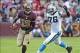Nov 4, 2012; Landover, MD, USA; Washington Redskins quarterback Robert Griffin III (10) avoids the tackle of Carolina Panthers defensive end Greg Hardy (76) during the second half at FedEX Field. Mandatory Credit: Brad Mills-USA TODAY Sports
