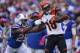 ORCHARD PARK, NY - OCTOBER 13: A.J. Green #18 of the Cincinnati Bengals picks up 55 yards on a catch during NFL game action as Da'Norris Searcy #25 of the Buffalo Bills tackles him at Ralph Wilson Stadium on October 13, 2013 in Orchard Park, New York. (Ph