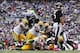 Oct 13, 2013; Baltimore, MD, USA; Baltimore Ravens quarterback Joe Flacco (5) watches as running back Ray Rice (27) is tackled by the Green Bay Packers defense at M&T Bank Stadium. Mandatory Credit: Mitch Stringer-USA TODAY Sports
