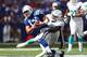 INDIANAPOLIS, IN - SEPTEMBER 15: Andrew Luck #12 of the Indianapolis Colts runs with the ball while being tackled by Dannell Ellerbe #59 of the Miami Dolphins during the Dolphins 24-20 win at Lucas Oil Stadium on September 15, 2013 in Indianapolis, India