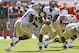 MIAMI GARDENS, FL - OCTOBER 5: Vad Lee #2 of the Georgia Tech Yellow Jackets hands the ball off to Daniel Drummond #30 against the Miami Hurricanes on October 5, 2013 at Sun Life Stadium in Miami Gardens, Florida. (Photo by Joel Auerbach/Getty Images)