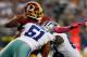 ARLINGTON, TX - OCTOBER 13: Robert Griffin III #10 of the Washington Redskins fumbles the ball while being sacked by Kyle Wilber #51 of the Dallas Cowboys and George Selvie #99 of the Dallas Cowboys in the fourth quarter on October 13, 2013 in Arlingto