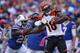 ORCHARD PARK, NY - OCTOBER 13: A.J. Green #18 of the Cincinnati Bengals picks up 55 yards on a catch during NFL game action as Da'Norris Searcy #25 of the Buffalo Bills tackles him at Ralph Wilson Stadium on October 13, 2013 in Orchard Park, New York. (Ph