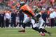 DENVER, CO - OCTOBER 13: Tight end Julius Thomas #80 of the Denver Broncos makes a reception as cornerback Mike Harris #20 of the Jacksonville Jaguars makes the tackle at Sports Authority Field at Mile High on October 13, 2013 in Denver, Colorado. The Br