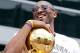 LOS ANGELES, CA - JUNE 21: Los Angeles Lakers guard Kobe Bryant laughs with the championship trophy while riding in the victory parade for the the NBA basketball champion team on June 21, 2010 in Los Angeles, California. The Lakers beat the Boston Celtic