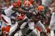 CLEVELAND, OH - SEPTEMBER 29: Running back Willis McGahee #26 of the Cleveland Browns runs as is tackled by defenders Geno Atkins #97 and Brandon Thompson #98 of the Cincinnati Bengals at FirstEnergy Stadium on September 29, 2013 in Cleveland, Ohio. (Ph