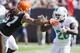 CLEVELAND, OH - SEPTEMBER 8: Linebacker Jabaal Sheard #97 of the Cleveland Browns tries to tackle running back Lamar Miller #26 of the Miami Dolphins during the second half at First Energy Stadium on September 8, 2013 in Cleveland, Ohio. The Dolphins defe