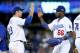 LOS ANGELES, CA - OCTOBER 06: Adrian Gonzalez #23 and Yasiel Puig #66 of the Los Angeles Dodgers celebrate the Dodgers 13-6 victory against the Atlanta Braves during Game Three of the National League Division Series at Dodger Stadium on October 6, 2013 i