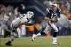 Sep 12, 2013; Foxborough, MA, USA; New England Patriots quarterback Tom Brady (12) scrambles away from New York Jets defensive end Sheldon Richardson (91) during the second quarter at Gillette Stadium. Mandatory Credit: Greg M. Cooper-USA TODAY Sports