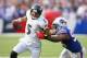 ORCHARD PARK, NY - SEPTEMBER 29: Joe Flacco #5 of the Baltimore Ravens tries to run away from Mario Williams #94 of the Buffalo Bills at Ralph Wilson Stadium on September 29, 2013 in Orchard Park, New York.Buffalo won 23-20. (Photo by Rick Stewart/Gett