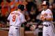 BALTIMORE, MD - SEPTEMBER 24: Brian Roberts #1 of the Baltimore Orioles celebrates with teammate Nate McLouth #9 after Roberts hit a home run against the Toronto Blue Jays in the third inning at Oriole Park at Camden Yards on September 24, 2013 in Baltim