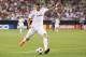 GLENDALE, AZ - AUGUST 01: Karim Benzema #9 of Real Madrid shoots to score a second half goal against the Los Angeles Galaxy during the International Champions Cup match at University of Phoenix Stadium on August 1, 2013 in Glendale, Arizona. (Photo by C