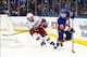 Feb. 24, 2013; Uniondale, NY, USA; New York Islanders center Keith Aucoin (10) handles the puck as Carolina Hurricanes defenseman Justin Faulk (27) gives chase during the third period at Nassau Veterans Memorial Coliseum. Carolina won 4-2. Mandatory Credi