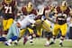 ARLINGTON, TX - OCTOBER 13: Robert Griffin III #10 of the Washington Redskins has the ball stripped by Jason Hatcher #97 of the Dallas Cowboys at AT&T Stadium on October 13, 2013 in Arlington, Texas. The Cowboys defeated the Redskins 31-16. (Photo by W