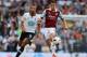 LONDON, ENGLAND - OCTOBER 06: Ravel Morrison of West Ham (R) avoids the tackle of Mousa Dembele of Tottenham during the Barclays Premier League match between Tottenham Hotspur and West Ham United at White Hart Lane on October 6, 2013 in London, England.