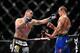 Dec 29, 2012; Las Vegas, NV, USA; Cain Velasquez (left) strikes Junior Dos Santos (right) during UFC 155 at the MGM Grand Garden Arena. Mandatory Credit: Gary A. Vasquez-USA TODAY Sports