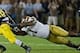 Sep 7, 2013; Ann Arbor, MI, USA; Michigan Wolverines running back Fitzgerald Toussaint (28) carries the ball as Notre Dame Fighting Irish nose tackle Louis Nix (1) and linebacker Jarrett Grace (59) defend in the third quarter at Michigan Stadium. Michigan