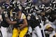 BALTIMORE, MD - DECEMBER 02: Running back Isaac Redman #33 of the Pittsburgh Steelers is pulled down by a pack of Baltimore Ravens defenders in the third quarter at M&T Bank Stadium on December 2, 2012 in Baltimore, Maryland. The Pittsburgh Steelers won,