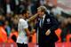 LONDON, ENGLAND - OCTOBER 15: England manager Roy Hodgson shakes hands with Andros Townsend of England as they qualify for the World Cup in Brazil after the FIFA 2014 World Cup Qualifying Group H match between England and Poland at Wembley Stadium on Oct