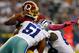 ARLINGTON, TX - OCTOBER 13: Robert Griffin III #10 of the Washington Redskins fumbles the ball while being sacked by Kyle Wilber #51 of the Dallas Cowboys and George Selvie #99 of the Dallas Cowboys in the fourth quarter on October 13, 2013 in Arlingto