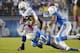SAN DIEGO, CA-OCTOBER-14: Stanley Havili #39 of the Indianapolis Colts is tackled by Derek Cox #22 of the San Diego Chargers at Qualcomm Stadium October 14, 2013 in San Diego, California. (Photo by Kevork Djansezian/Getty Images)