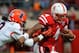 LINCOLN, NE - OCTOBER 5: Quarterback Tommy Armstrong Jr. #4 of the Nebraska Cornhuskers eludes defensive back Earnest Thomas III #9 of the Illinois Fighting Illini during their game at Memorial Stadium on October 5, 2013 in Lincoln, Nebraska. (Photo by Er