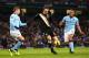MANCHESTER, ENGLAND - JANUARY 19: Dimitar Berbatov of Fulham controls the ball ahead of Matija Nastasic and Vincent Kompany of Manchester City during the Barclays Premier League match between Manchester City and Fulham at Etihad Stadium on January 19, 20