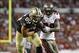 Dashon Goldson (right) attempts to tackle Jimmy Graham.