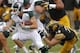 IOWA CITY, IOWA - OCTOBER 5: Quarterback Connor Cook #18 of the Michigan State Spartans breaks a tackle during the first quarter by defensive lineman Dominic Alvis #79 of the Iowa Hawkeyes on October 5, 2013 at Kinnick Stadium in Iowa City, Iowa. Michiga