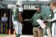 EAST RUTHERFORD, NJ - OCTOBER 13: Offensive coordinator Marty Mornhinweg of the New York Jets talks with quarterback Geno Smith #7 as back up quarterback Matt Simms #5 listens in during a game against the Pittsburgh Steelers at MetLife Stadium on October