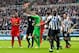 NEWCASTLE-UPON-TYNE, ENGLAND - OCTOBER 19: Referee Andre Marriner (2nd L) shows a red card to Mapou Yanga-Mbiwa (2nd R) of Newcastle for fouling Luis Suarez of Liverpool inside the penalty area and conceding penalty during the Barclays Premier League matc