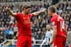 NEWCASTLE-UPON-TYNE, ENGLAND - OCTOBER 19: Steven Gerrard (L) of Liverpool celebrates scoring his 100th Premier League goal and his team's first with team-mate Jordan Henderson during the Barclays Premier League match between Newcastle United and Liverpoo
