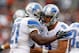 CLEVELAND, OH - OCTOBER 13: Quarterback Matthew Stafford #9 of the Detroit Lions celebrates a touchdown by running back Reggie Bush #21 against the Cleveland Browns at FirstEnergy Stadium on October 13, 2013 in Cleveland, Ohio. (Photo by Matt Sullivan/G