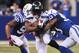 INDIANAPOLIS, IN - OCTOBER 06: Marshawn Lynch #24 of the Seattle Seahawks is taken down by Jerrell Freeman #50 and Kavell Conner #53 of the Indianapolis Colts during a game at Lucas Oil Stadium on October 6, 2013 in Indianapolis, Indiana. (Photo by Jona