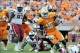 Oct 19, 2013; Knoxville, TN, USA; Tennessee Volunteers running back Marlin Lane (15) rushes against South Carolina Gamecocks safety Chris Moody (6) and South Carolina linebacker Kaiwan Lewis (8) during the second half at Neyland Stadium. Tennessee won 23-