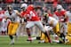 COLUMBUS, OH - OCTOBER 19: Carlos Hyde #34 of the Ohio State Buckeyes spins away from defenders John Lowdermilk #37 of the Iowa Hawkeyes and Anthony Hitchens #31 of the Iowa Hawkeyes in the second quarter for a 17-yard gain at Ohio Stadium on October 19,