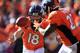 DENVER, CO - OCTOBER 13: Quarterback Peyton Manning #18 of the Denver Broncos tosses the ball to running back Knowshon Moreno #27 of the Denver Broncos against the Jacksonville Jaguars at Sports Authority Field at Mile High on October 13, 2013 in Denver,