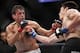 Oct 19, 2013; Houston, TX, USA; K.J. Noons (blue gloves) fights against George Sotiropoulos (red gloves) in their lightweight bout during UFC 166 at Toyota Center. Mandatory Credit: Andrew Richardson-USA TODAY Sports