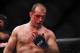 Oct 19, 2013; Houston, TX, USA; Junior Dos Santos (blue gloves) wipes blood off his face in the world heavyweight championship bout during UFC 166 at Toyota Center. Mandatory Credit: Andrew Richardson-USA TODAY Sports