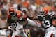 Sep 29, 2013; Cleveland, OH, USA; Cincinnati Bengals wide receiver Mohamed Sanu (12) defended by Cleveland Browns strong safety T.J. Ward (43) and cornerback Buster Skrine (22) during the second quarter at FirstEnergy Stadium. Mandatory Credit: Raj Mehta-