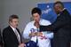 Dodgers GM Ned Colletti and owner Magic Johnson flank Hyun-Jin Ryu, who signed last winter.