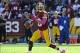 Oct 20, 2013; Landover, MD, USA; Washington Redskins quarterback Robert Griffin III (10) rolls out against the Chicago Bears during the first half at FedEX Field. Mandatory Credit: Brad Mills-USA TODAY Sports