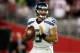 GLENDALE, AZ - OCTOBER 17: Quarterback Russell Wilson #3 of the Seattle Seahawks drops back to pass against the Arizona Cardinals during a game at the University of Phoenix Stadium on October 17, 2013 in Glendale, Arizona. (Photo by Christian Petersen/Ge